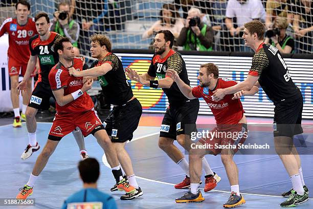 Players jostle for position during the handball international friendly match between Germany and Austria at Schwalbe arena on April 3, 2016 in...