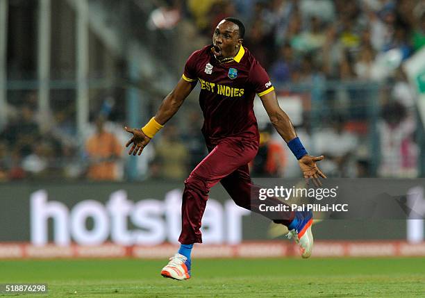 Dwayne Bravo of the West Indies runs to celebrate the wicket of Moeen Ali of England during ICC World Twenty20 India 2016 Final match between England...