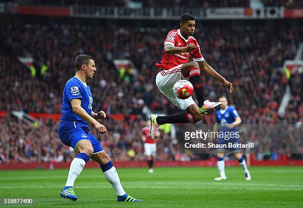 Marcus Rashford of Manchester United beats Phil Jagielka of Everton to the ball during the Barclays Premier League match between Manchester United...