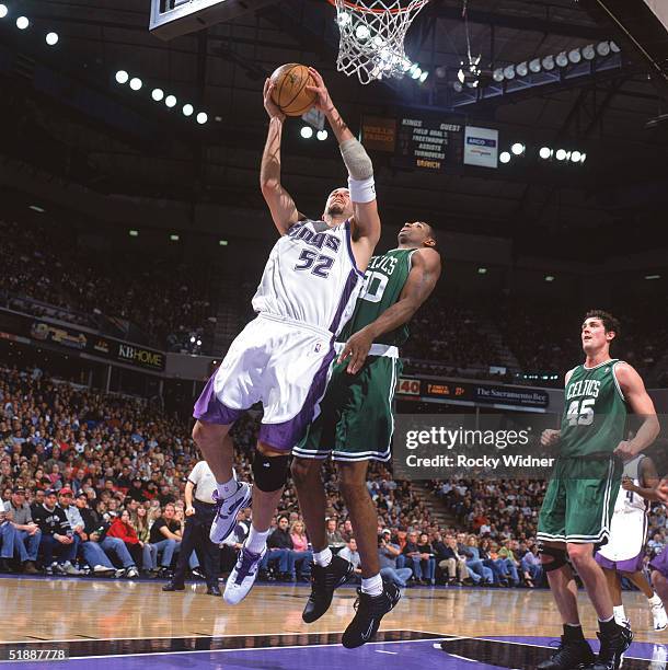 Brad Miller of the Sacramento Kings takes the ball to the basket against Mark Blount of the Boston Celtics during the game at Arco Arena on December...