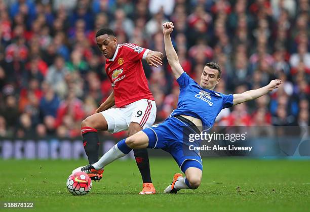 Seamus Coleman of Everton stretches to tackle Anthony Martial of Manchester United during the Barclays Premier League match between Manchester United...