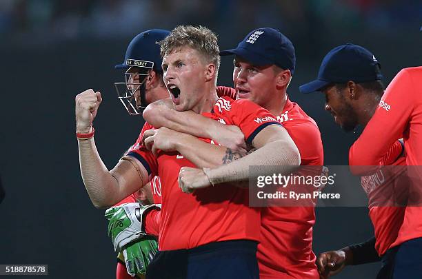 Joe Root of England celebrates after taking the wicket of Chris Gayle of the West Indies during the ICC World Twenty20 India 2016 Final match between...