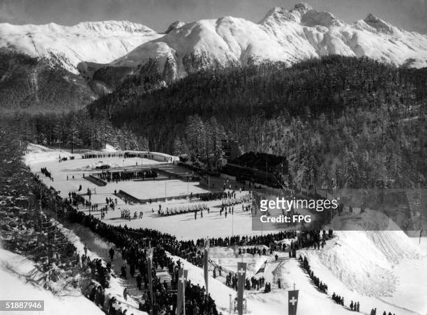 The American contingent of athletes into an outdoor stadium during the opening ceremonies of the 1948 Winter Olympics at St. Moritz, Switzerland,...