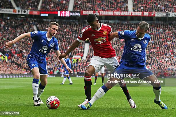 Tom Cleverley and Phil Jagielka of Everton compete with Marcus Rashford of Manchester United during the Barclays Premier League match between...