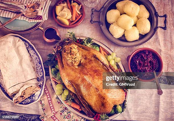 traditional german holiday goose dinner with dumplings and red cabbage - goose meat stock pictures, royalty-free photos & images