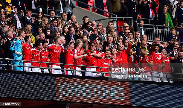 Conor Hourihane of Barnsley lifts the trophy as the Barnsley players celebrate following victory during the Johnstone's Paint Trophy Final between...