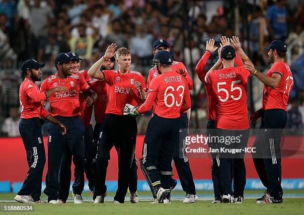 Joe Root of England celebrates the wicket of Chris Gayle of the West Indies with team mates during the ICC World Twenty20 India 2016 final match...