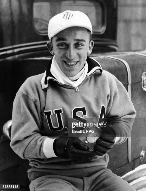 American speed skater Irving Jaffee holds his gold medal after winning the men's 10,000-meter speed skating event at the 1932 Winter Olympic Games,...