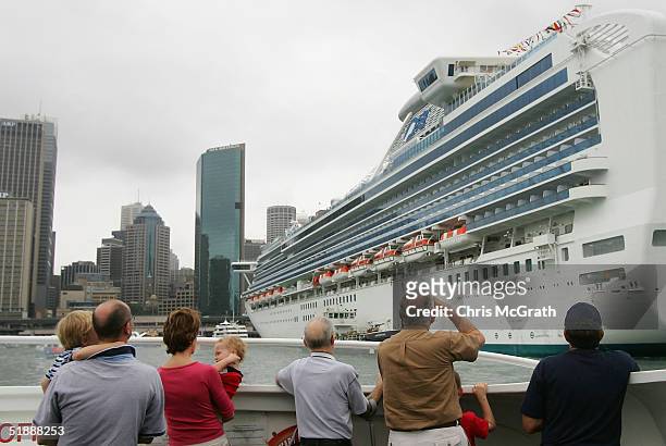 Sydney Ferry commuters take photographs as they pass by the Sapphire Princess docked at Circular Quay December 23, 2004 in Sydney, Australia. The P&O...