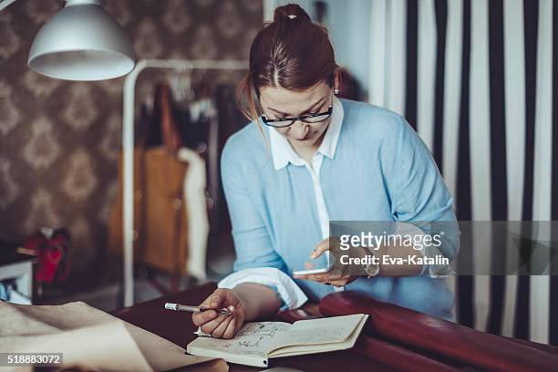 craftswoman working in her workshop - leather notebook stock pictures, royalty-free photos & images