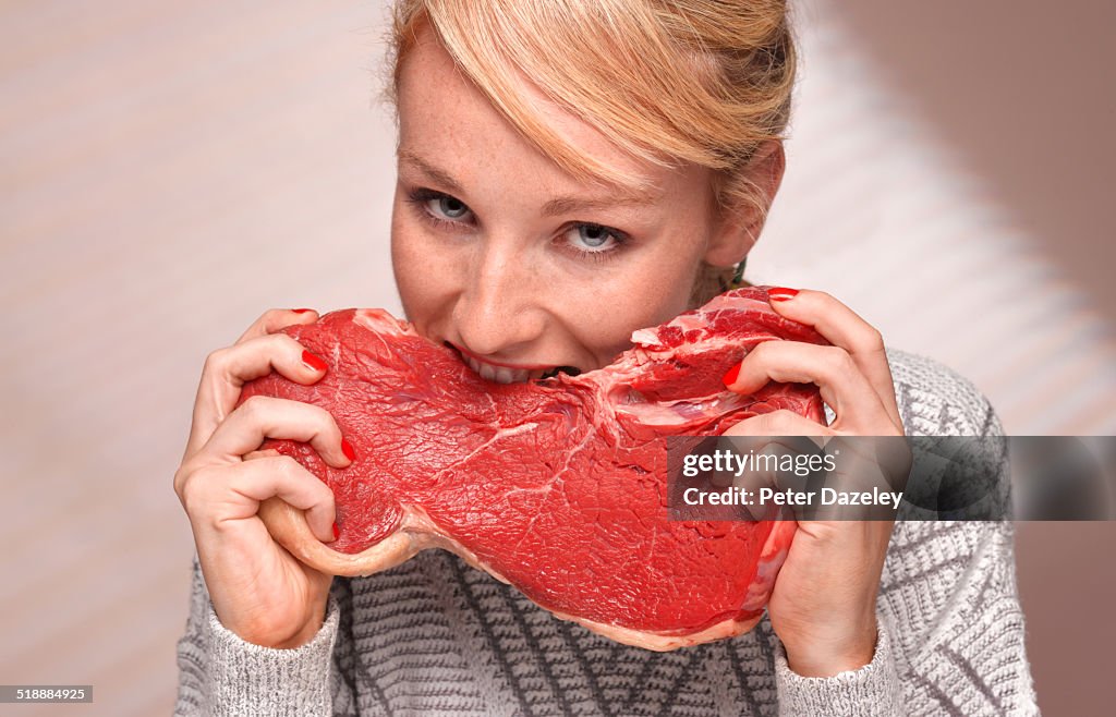 Woman eating steak