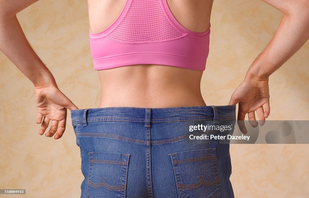 Dieting woman in jeans too large