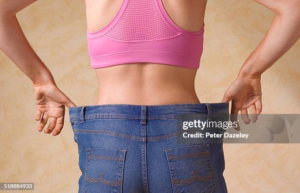 dieting woman in jeans too large - magro imagens e fotografias de stock