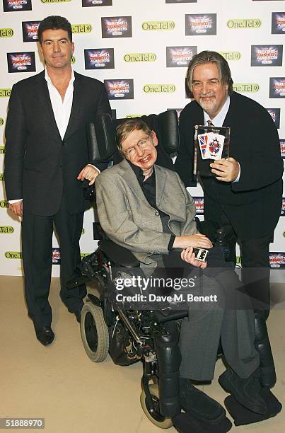 Presenter Simon Cowell, scientist Stephen Hawking and Matt Groening pose in the Awards Room with his award for Best International Comedy Show at the...