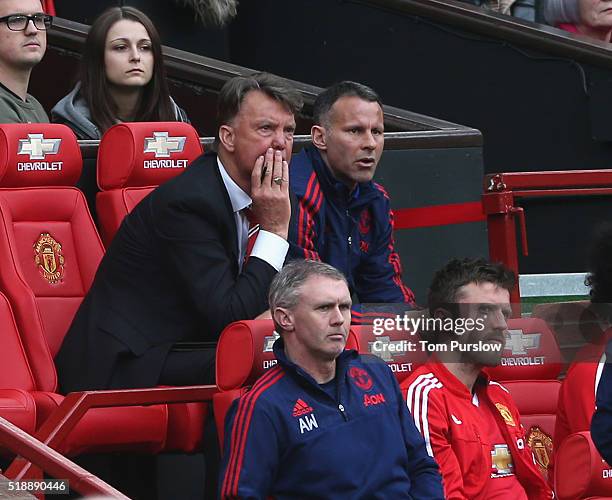 Manager Louis van Gaal and Assistant Manager Ryan Giggs of Manchester United watch from the dugout during the Barclays Premier League match between...