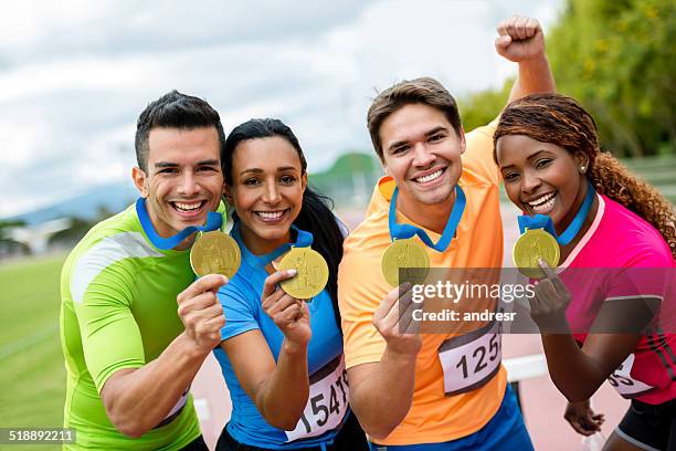 runners with gold medals - marathon medal stock pictures, royalty-free photos & images