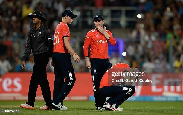 Joe Root, captain Eoin Morgan and Ben Stokes of England react after losing the ICC World Twenty20 India 2016 Final between England and the West...