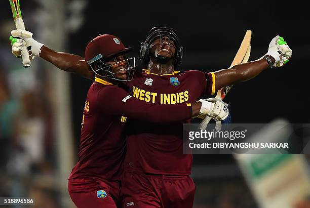 West Indies's Carlos Brathwaiteand teammate Marlon Samuels celebrate after victory in the World T20 cricket tournament final match between England...