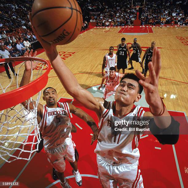 Yao Ming of the Houston Rockets makes a rebound against the San Antonio Spurs at Toyota Center on December 9, 2004 in Houston, Rockets. The Rockets...