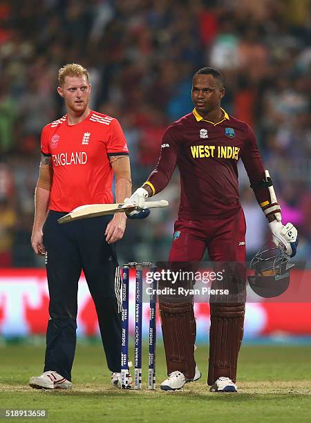 Marlon Samuels of the West Indies celebrates after Carlos Brathwaite of the West Indies hit the second six of the last over as Ben Stokes of England...