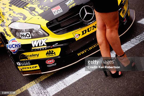 Grid girl stands in front of the car of Adam Morgan of WIX Racing Mercedes Benz before race three of the Dunlop MSA British Touring Car Championship...