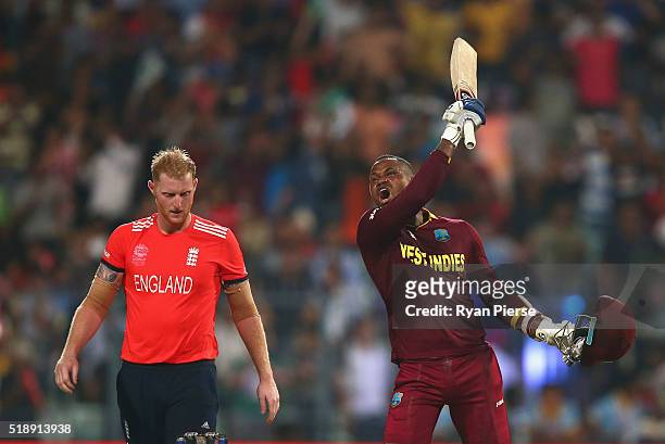 Marlon Samuels of the West Indies celebrates after Carlos Brathwaite of the West Indies hit the second six of the last over as Ben Stokes of England...