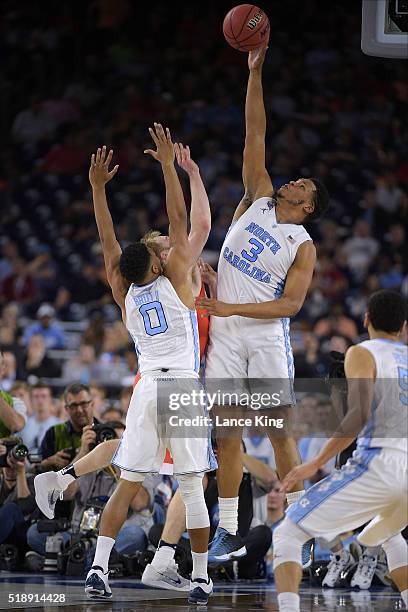 Kennedy Meeks of the North Carolina Tar Heels defends a shot by Trevor Cooney of the Syracuse Orange during the 2016 NCAA Men's Final Four Semifinal...