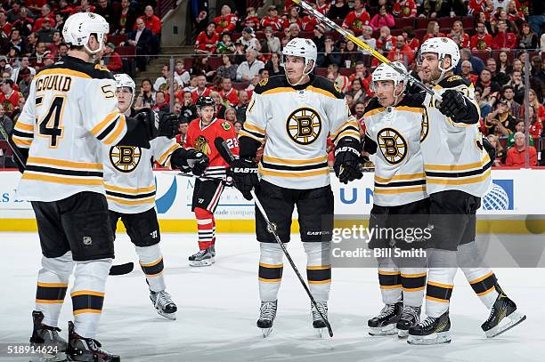 Patrice Bergeron of the Boston Bruins celebrates with Loui Eriksson and Brad Marchand after scoring against the Chicago Blackhawks in the second...