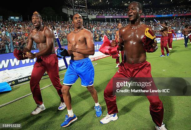 Andre Russell of the West Indies, Dwayne Bravo of the West Indies and Darren Sammy, Captain of the West Indies celebrate their teams win over England...