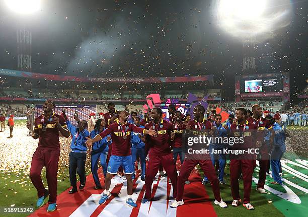 Darren Sammy, Captain of the West Indies and his team celebrate with the trophy during the ICC World Twenty20 India 2016 final match between England...