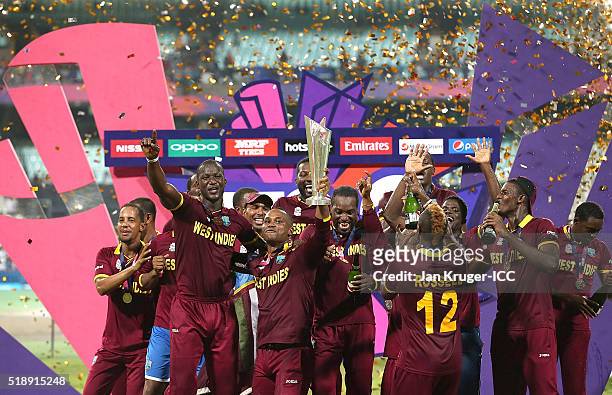 Darren Sammy, Captain of the West Indies and his team celebrate with the trophy during the ICC World Twenty20 India 2016 final match between England...