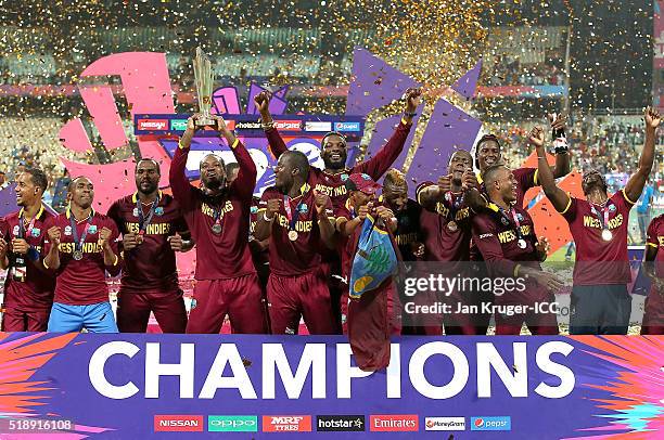 Darren Sammy, Captain of the West Indies and his team celebrate with the trophy during the ICC World Twenty20 India 2016 final match between England...