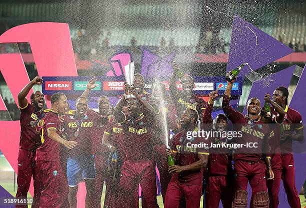 Darren Sammy, Captain of the West Indies and his team celebrate with the trophy during the ICC World Twenty20 India 2016 final match between England...