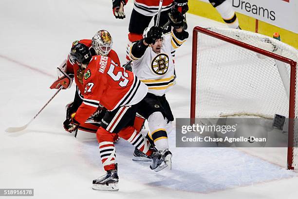 Brad Marchand of the Boston Bruins scores on goalie Scott Darling of the Chicago Blackhawks in the third period of the NHL game at the United Center...