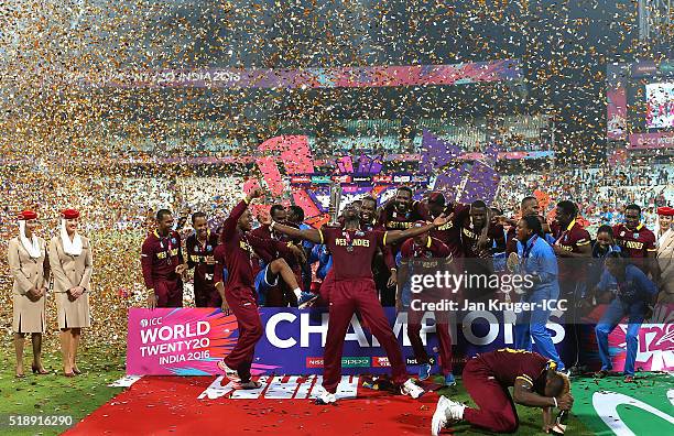 Darren Sammy, Captain of the West Indies and his team celebrate with the trophy during the ICC World Twenty20 India 2016 final match between England...