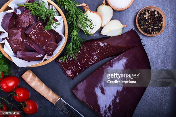 raw beef liver over gray background viewed from above - higado fotografías e imágenes de stock