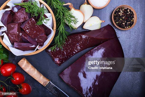 raw beef liver over gray background viewed from above - liver stockfoto's en -beelden