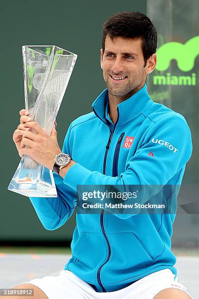 Novak Djokovic of Serbia poses with the Butch Buchholz trophy after defeating Kei Nishikori of Japan during the final on Day 14 of the Miami Open...