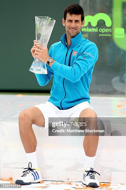 Novak Djokovic of Serbia poses with the Butch Buchholz trophy after defeating Kei Nishikori of Japan during the final on Day 14 of the Miami Open...