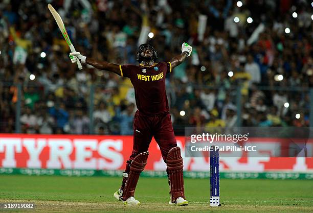 Carlos Brathwaite of the West Indies celebrates after hitting the winnign run during ICC World Twenty20 India 2016 Final match between England and...