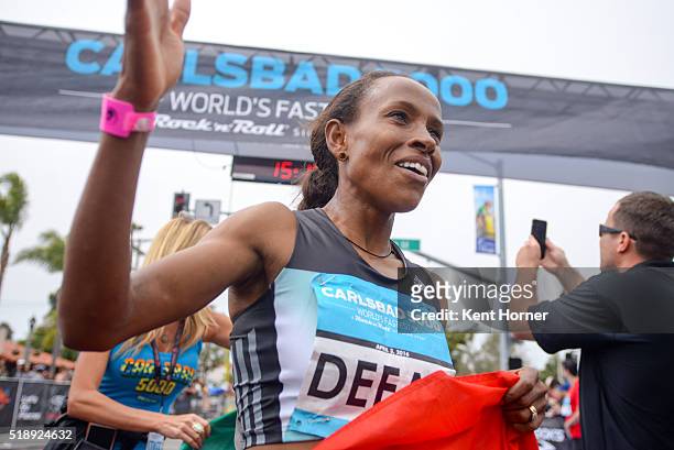 Meseret Defar of Ethiopia celebrates at the finish line after finishing first in the Elite field at the Carlsbad 5000 on April 3, 2016 in Carlsbad,...