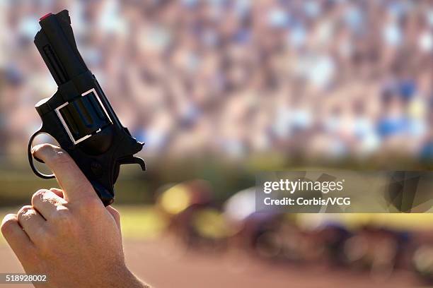 starting gun at an athletics event - pistola de salida fotografías e imágenes de stock