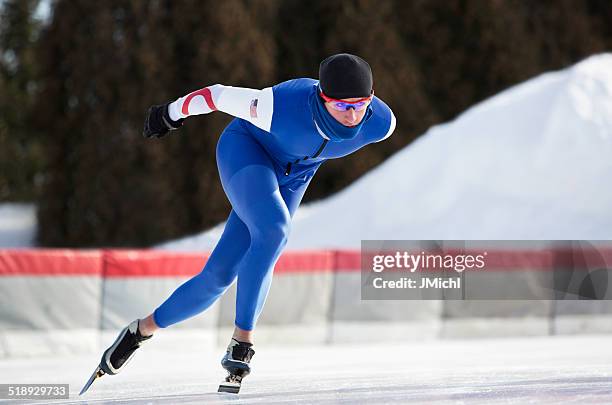male athlete speed skating on a cold winter day. - schaatsen stockfoto's en -beelden
