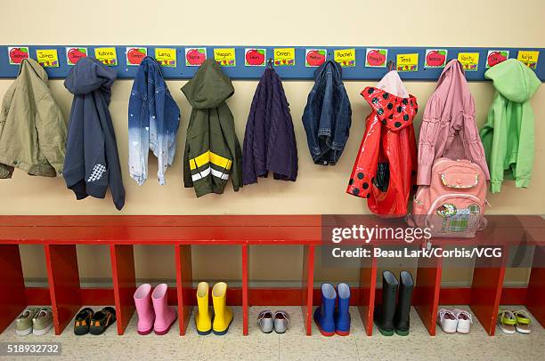 coats and boots in a preschool classroom - coat stand stock pictures, royalty-free photos & images