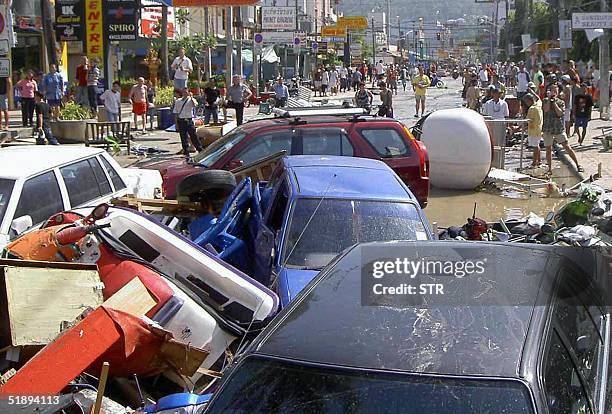 Foreign tourists look at damage caused by a tsunami in Phuket island, southern of Thailand, 26 December 2004. At least 118 people were killed and...
