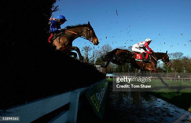 Ollie Magern ridden by Carl Llewellyn jumps the water jump on his way to winning the Stan James Feltham Novices Steeple Chase at Kempton Park...