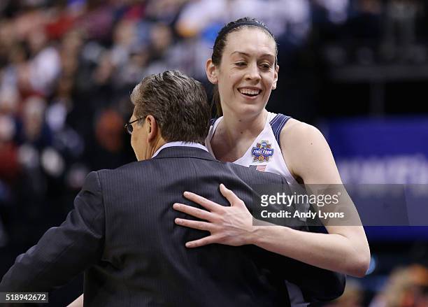 Head coach Geno Auriemma of the Connecticut Huskies and Breanna Stewart celebrate their 80-51 win over the Oregon State Beavers during the semifinals...