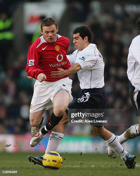 Wayne Rooney of Manchester United beats Tal Ben Haim of Bolton Wanderers during the Barclays Premiership match between Manchester United and Bolton...