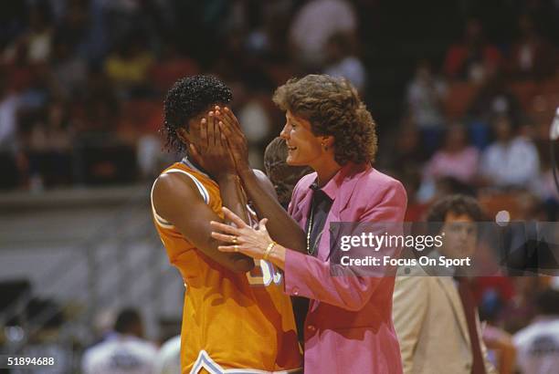 Bridgette Gordon of the Tennessee Lady Vols covers her face and talks to coach Pat Summit in the Final Four game against Long Beach State during the...