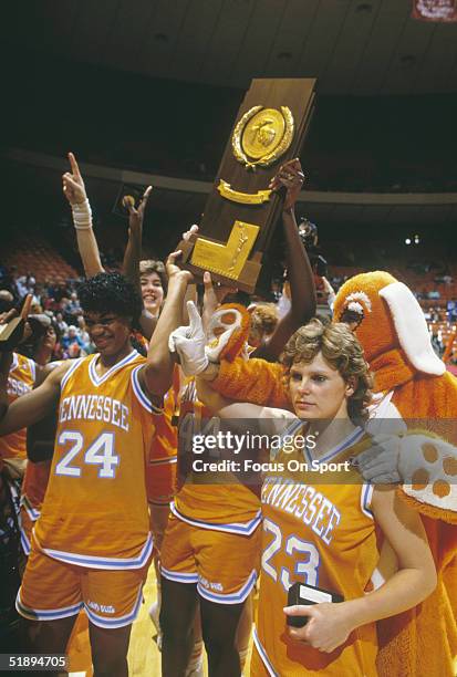 Tennessee Lady Volunteers Carla McGhee, Shelly Sexton, and the rest of the Lady Vols team hold up the Women's NCAA Basketball Championship trophy...